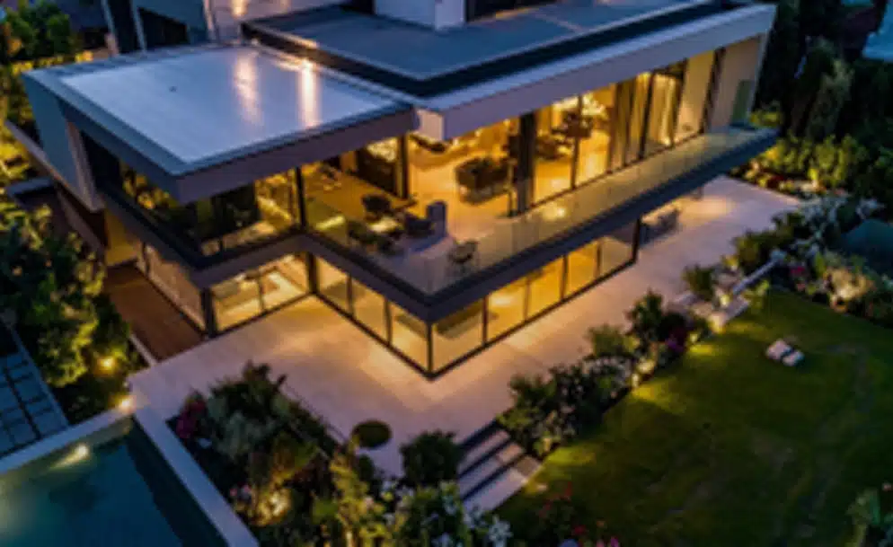 a modern two-story house at night, captured from an elevated angle new